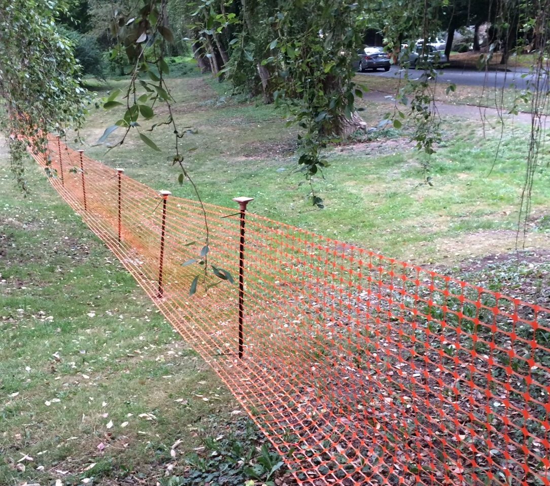 High visibility fence installed on an undisturbed area attached to metal stakes
